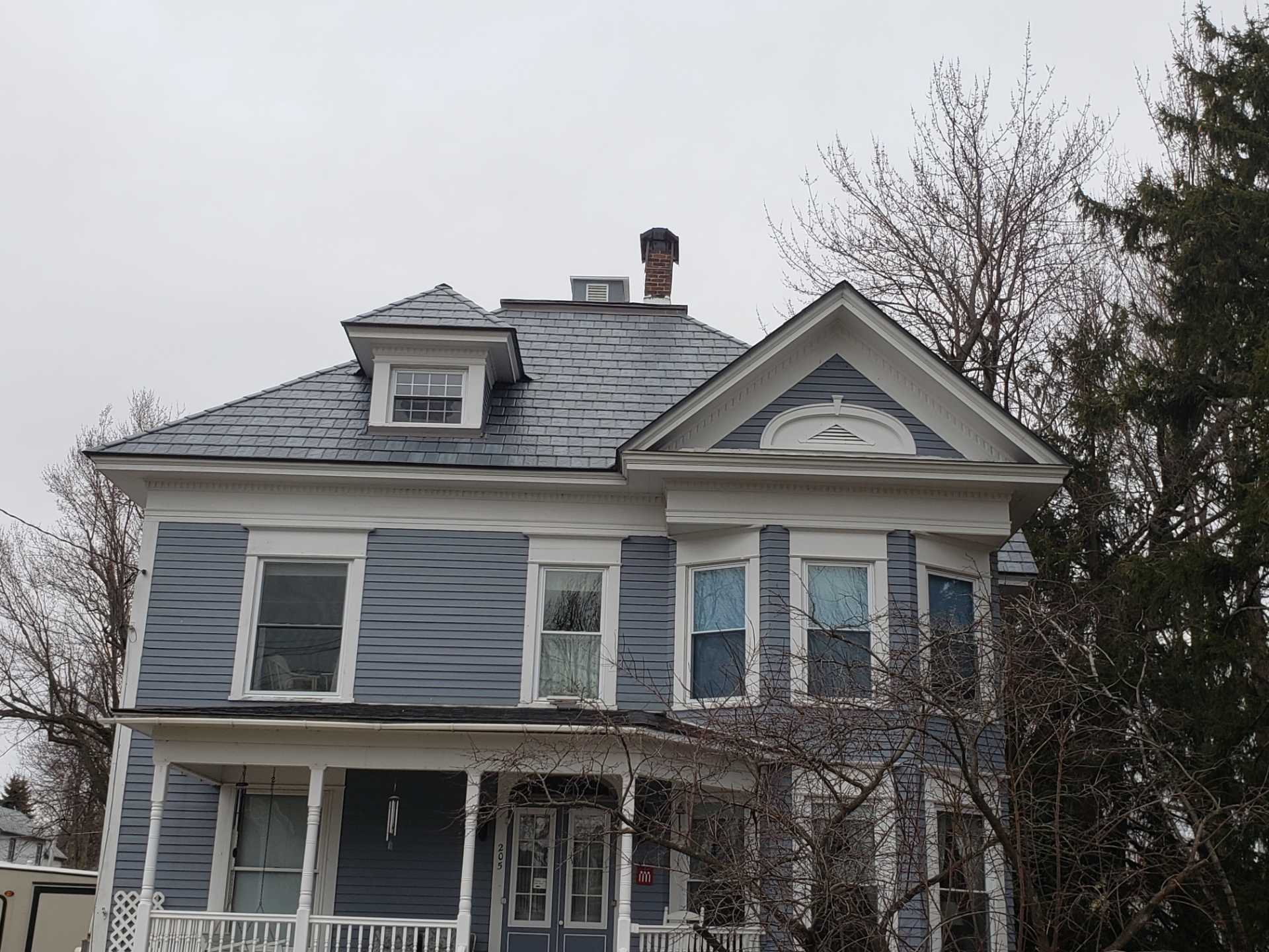 Blue Victorian house with white trim details.