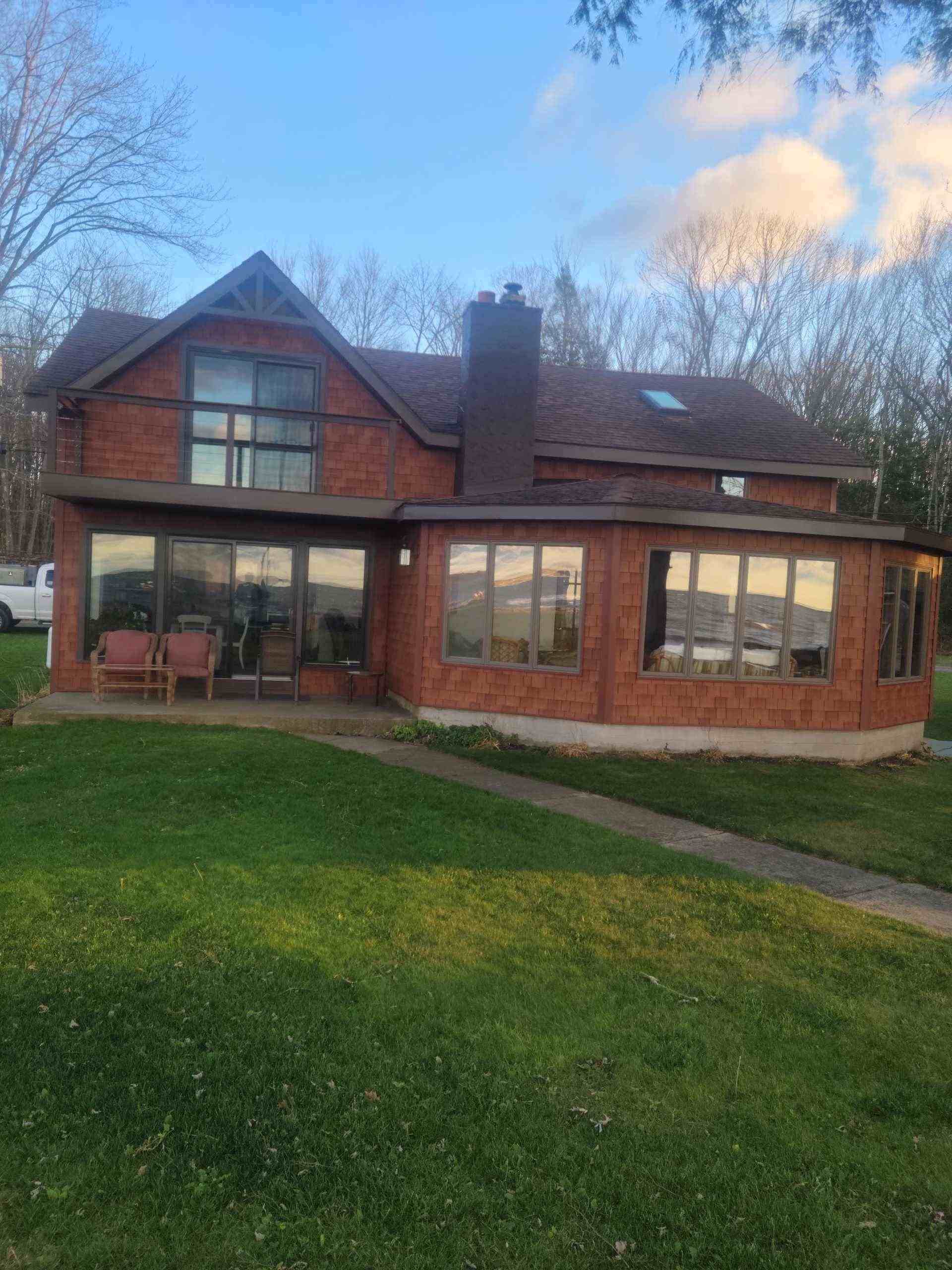 Modern wooden house with a green lawn.